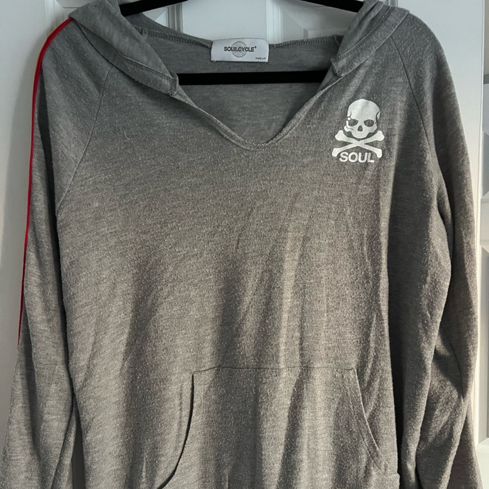 SoulCycle thin sweatshirt with rainbow stripes on sleeves